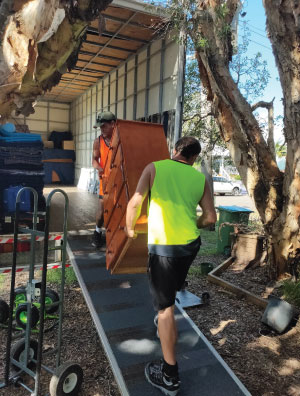 Wyong Removals & Storage team lifting a a set of drawers into the back of the removalist truck