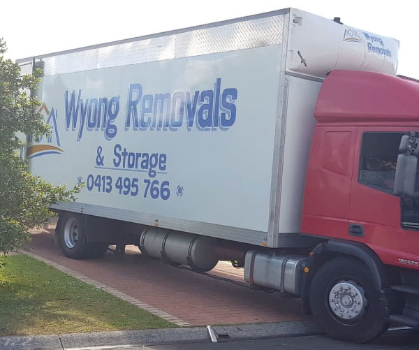 Wyong Removals & Storage truck parked on a driveway unpacking belongings for a customer