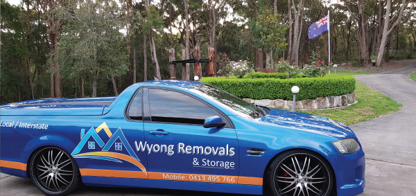 Wyong Removals & Storage ute parked with Australian flag flying in the background